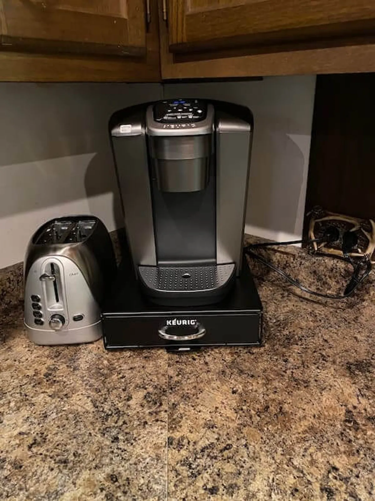 A close-up of a Keurig coffee maker and toaster set on a spacious countertop, suggesting the perfect spot for preparing morning coffee or quick breakfasts. The setup feels casual and welcoming, ideal for starting the day or gathering for a casual brunch.